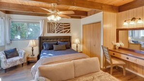 A bedroom with a bed, a desk, a chair, a ceiling fan, and a window. - A-frame Home w/ 3 Decks & Lake Arrowhead Views! (Lake Arrowhead)