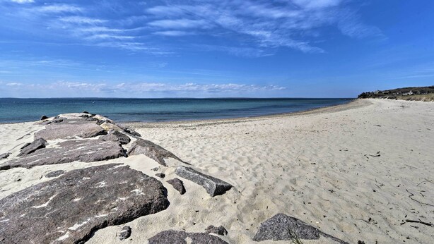 A beach with large rocks in the foreground and a clear blue sky. - Peaceful Chilmark Farmhouse by Menemsha Beach (Chilmark)