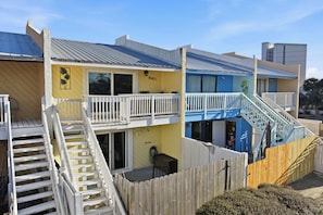 A two-story building with a balcony and a staircase. - Walk to Beach! The Sage PCB Family Getaway (Panama City Beach)
