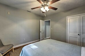 A bedroom with a bed, a ceiling fan, and a door. - Pet Friendly Gainesville Getaway ~ 2 Mi to UF (Gainesville)