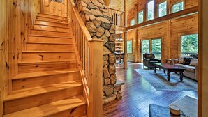 A wooden staircase with a stone wall, a wooden ceiling, and large windows. - Private Chester Home w/ Deck, Mins to Skiing! (Chester)