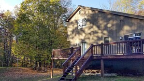 A wooden cabin with a deck and stairs, surrounded by trees. - Dover Home: 7 Mi to Mount Snow Grand Summit Resort (East Dover)