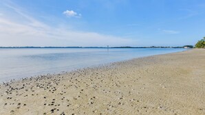 A beach with a clear sky and calm water. - Walk to Beach: Home w/ Porch on Anna Maria Island! (Holmes Beach)