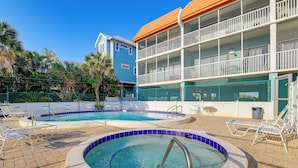 A hotel with a pool area, including a hot tub and lounge chairs. - Pelican Cove Condo at Bradenton Beach w/ Pool! (Bradenton Beach)
