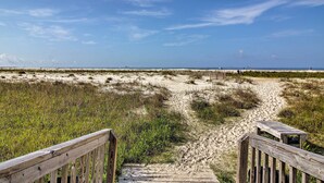 A sandy beach path leading to the ocean with wooden railings on both sides. - Dauphin Island Top-floor Condo w/ Resort Perks! (Dauphin Island)
