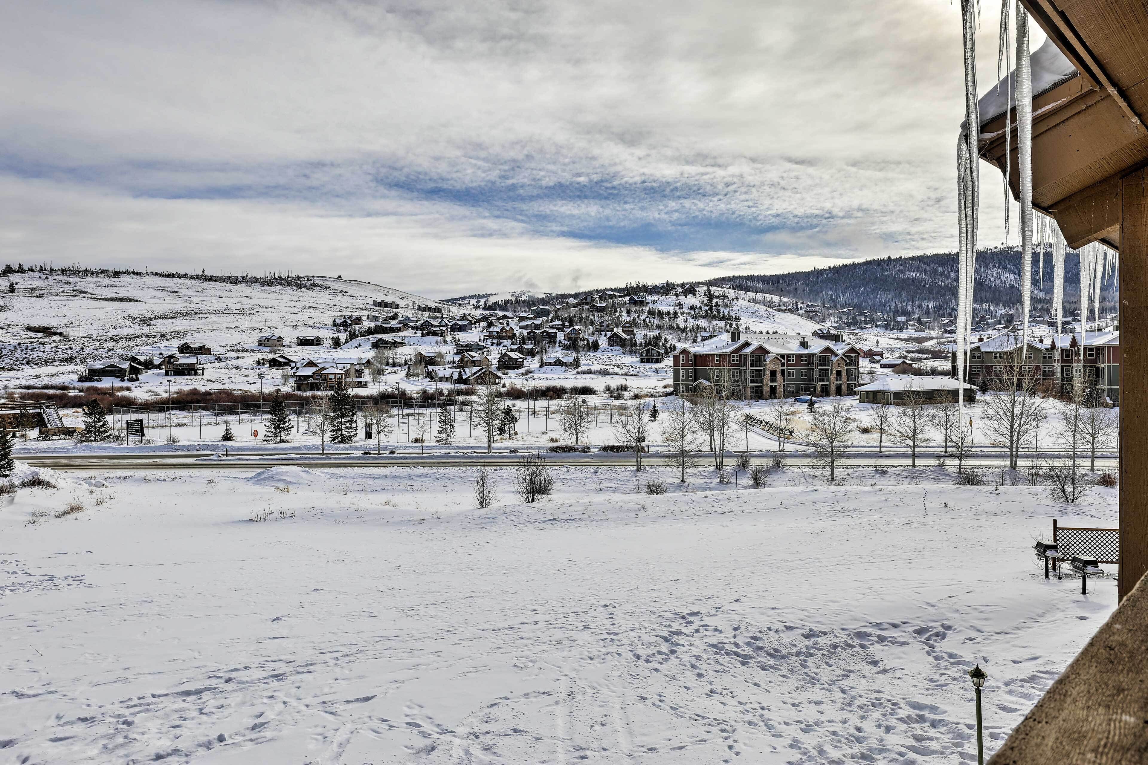 Un pueblo nevado con casas y una carretera.