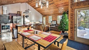 A spacious kitchen with modern appliances, a dining area with a wooden table, and a cozy living room with a fireplace. - Luxury Mountain Getaway in Fairplay w/ Deck! (Fairplay)