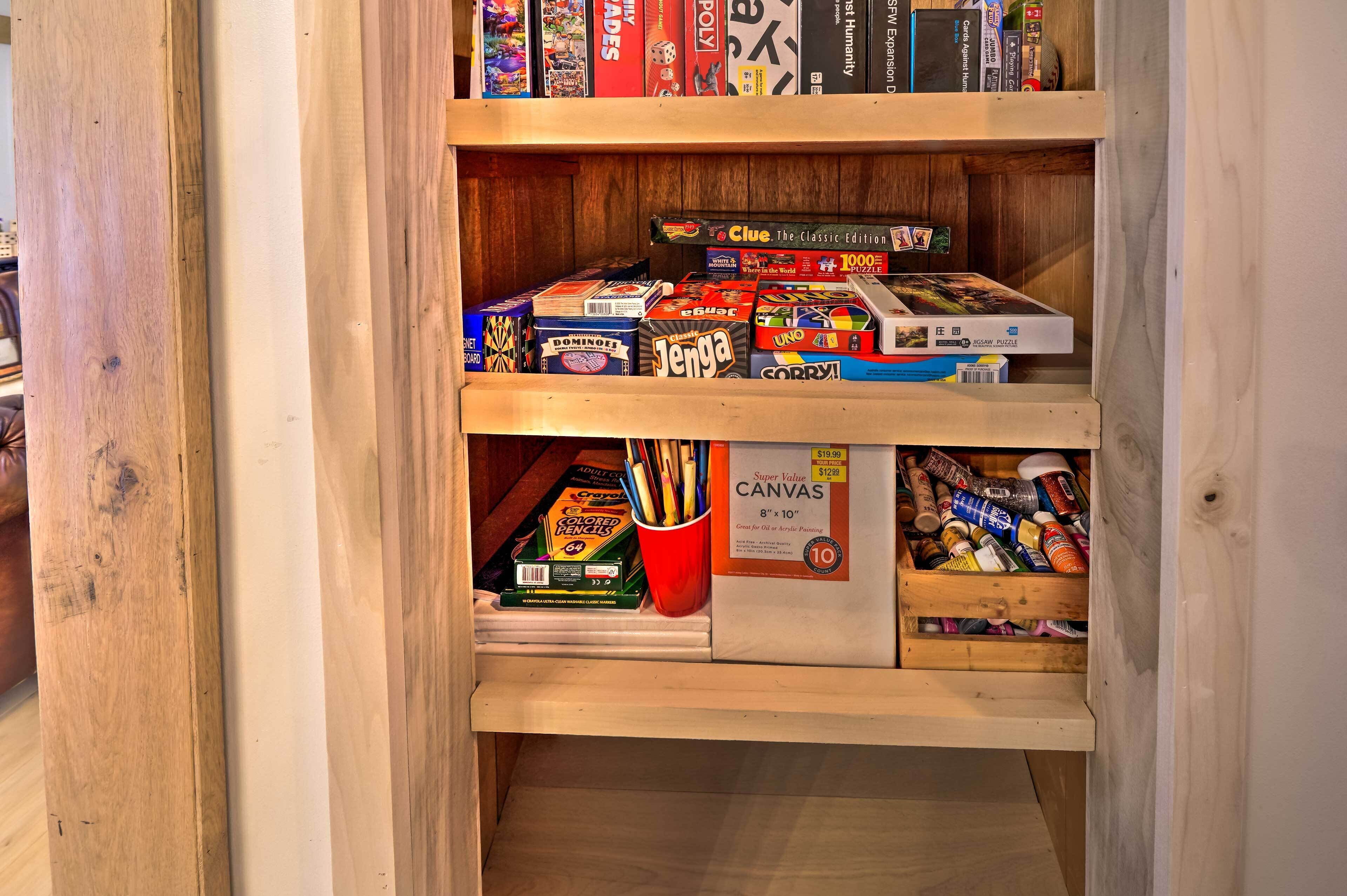A wooden bookshelf with various board games and puzzles.