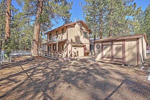 A two-story house with a large deck and a garage.