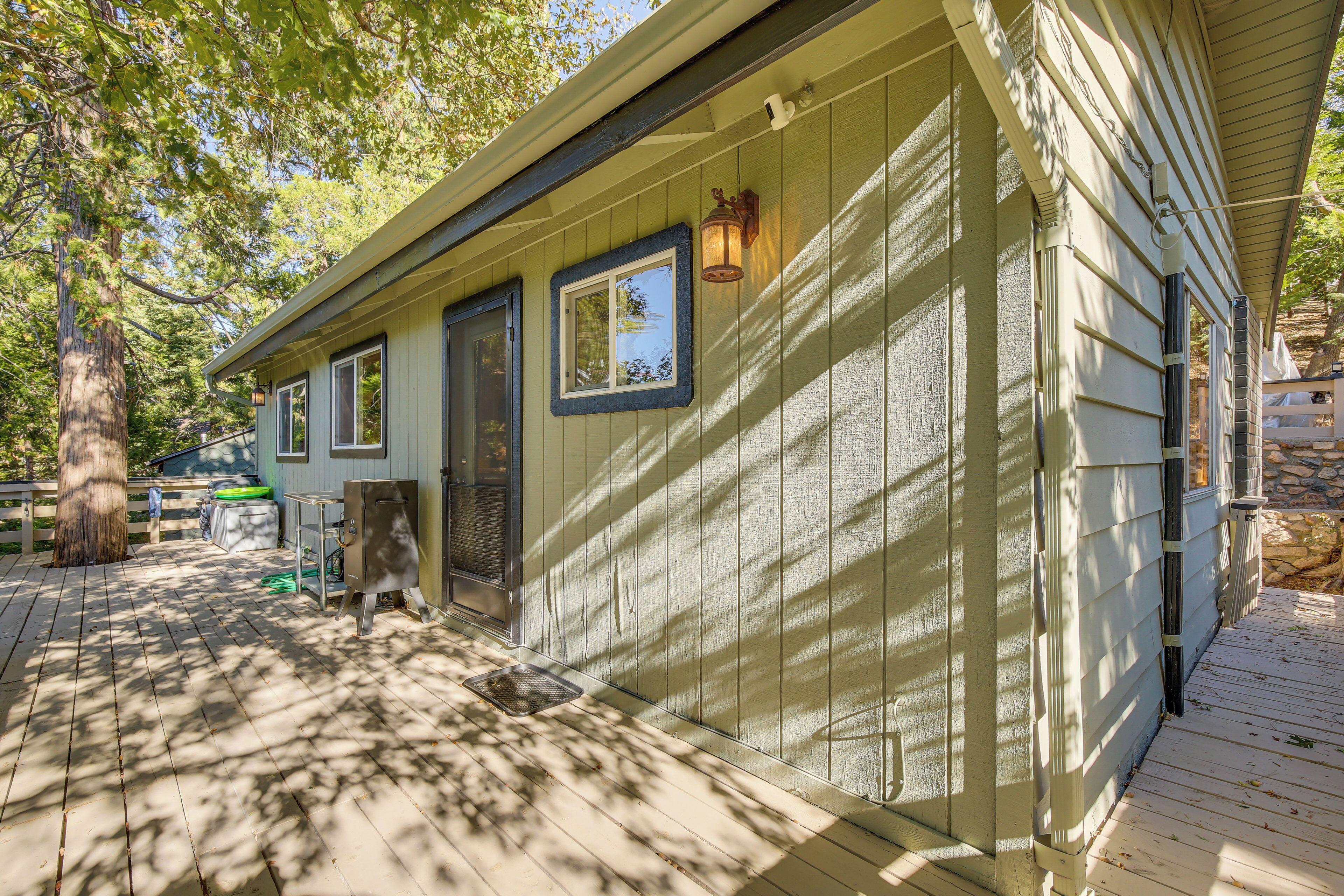 A wooden deck with a house in the background.