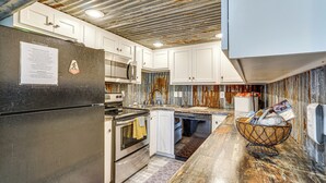 A modern kitchen with stainless steel appliances, white cabinetry, and a marble countertop. - 3 Cabins! Lakefront Reunion Retreat in Rocky Mount (Rocky Mount)