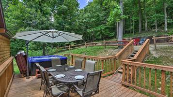 Enjoy dining al fresco on the deck, surrounded by nature, with a hot tub nearby.