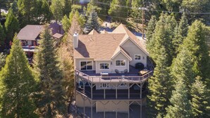 A two-story house with a balcony, surrounded by trees. - Lake Arrowhead Retreat w/ Decks + Mountain Views! (Lake Arrowhead)