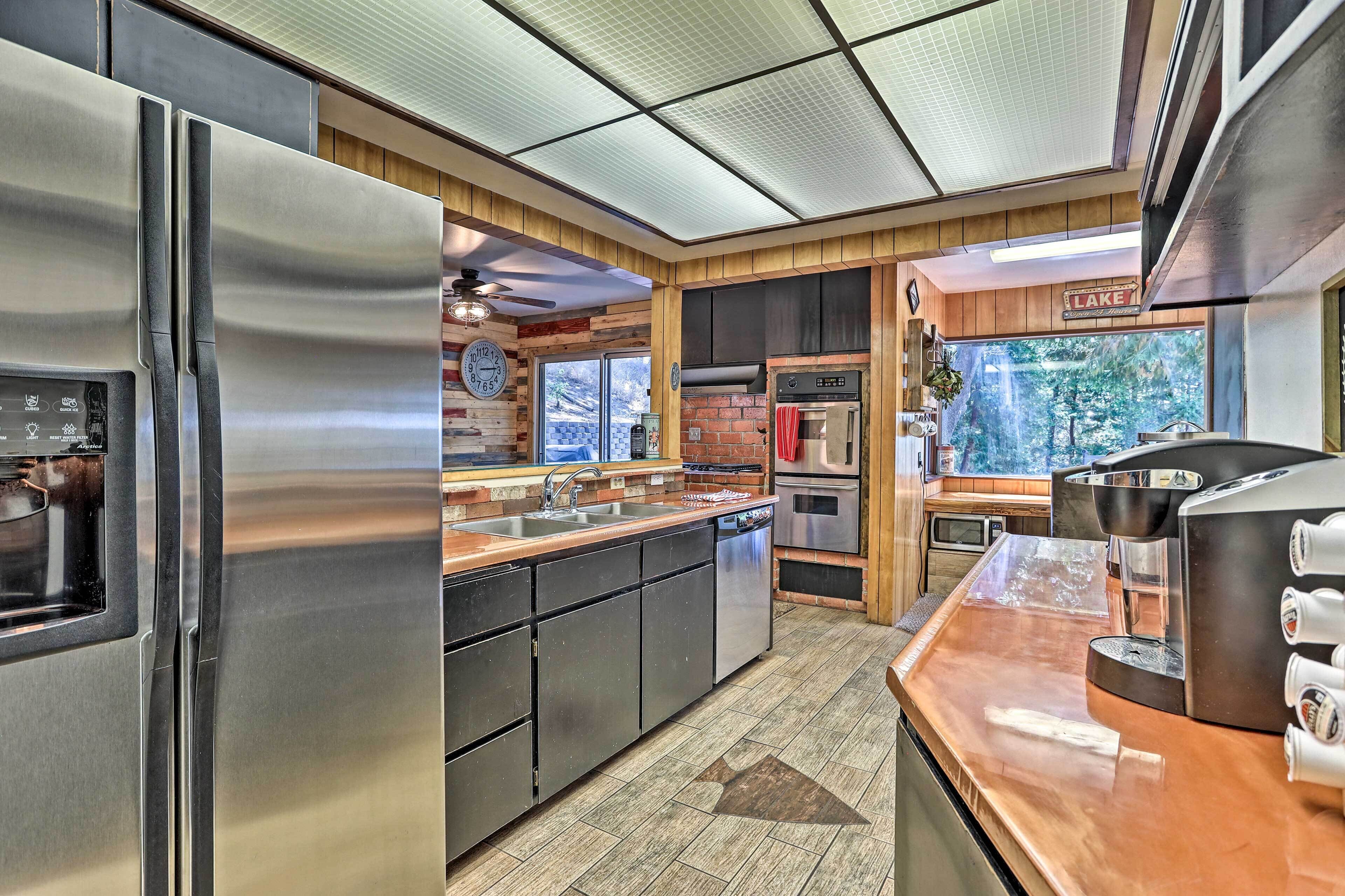 A modern kitchen with stainless steel appliances, a dishwasher, and a coffee machine.