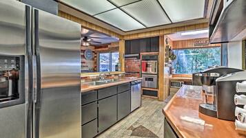A modern kitchen with stainless steel appliances, a dishwasher, and a coffee machine.