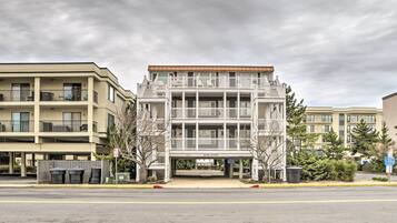 A multi-story hotel with a central entrance and balconies.