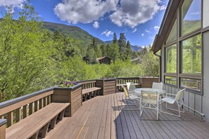 A wooden deck with outdoor furniture, overlooking a mountainous landscape. - Vail Condo w/ Mtn-view Deck - Steps to Ski Shuttle (Vail)