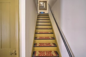 A staircase with yellow steps and red carpet runners. - 4BR Group Getaway on the Chickley River (Charlemont)