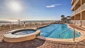 A swimming pool with a hot tub, a 3 FT depth marker, and a view of the ocean. - Resort Pool, Gym & Hot Tub: Beachfront PCB Condo! (Panama City Beach)