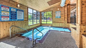 A wooden interior with a pool, wooden walls, and large windows. - Ski-in/ski-out Lutsen Retreat w/ Pool Access! (Lutsen)
