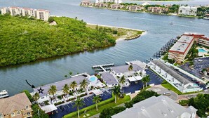 A coastal hotel with multiple buildings, a marina, and a view of the ocean.