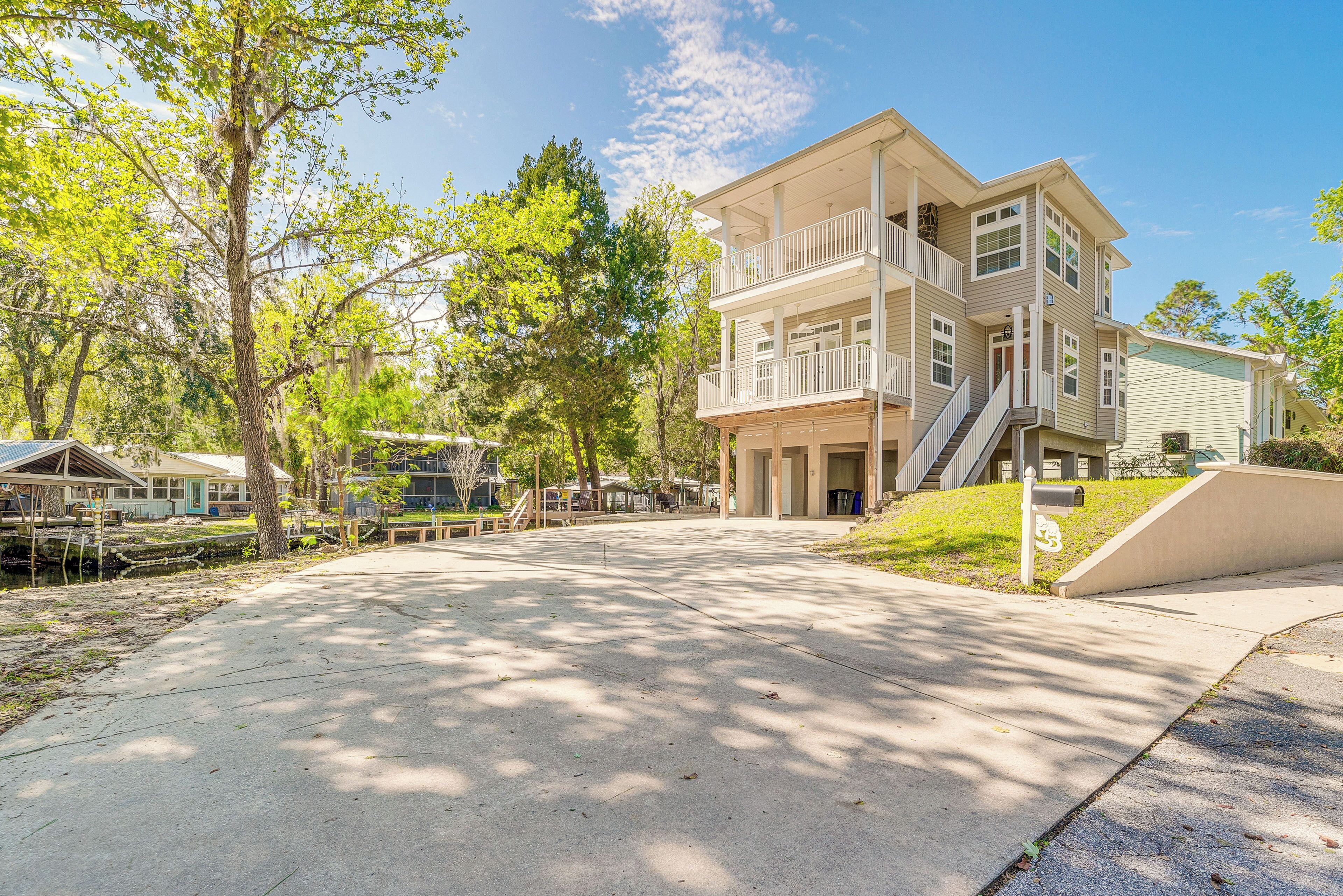 A two-story building with a balcony, a covered walkway, and a small ramp leading to the entrance.