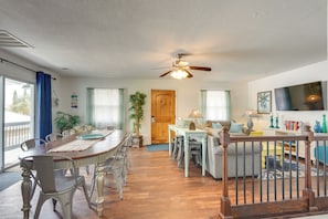 A spacious living area with a dining table, chairs, a sofa, and a ceiling fan. - PCB Group Retreat w/ Deck, 1 Block to Beach! (Panama City Beach)