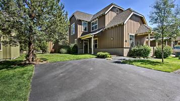 Stylish two-story home with a well-manicured front yard and mature trees.