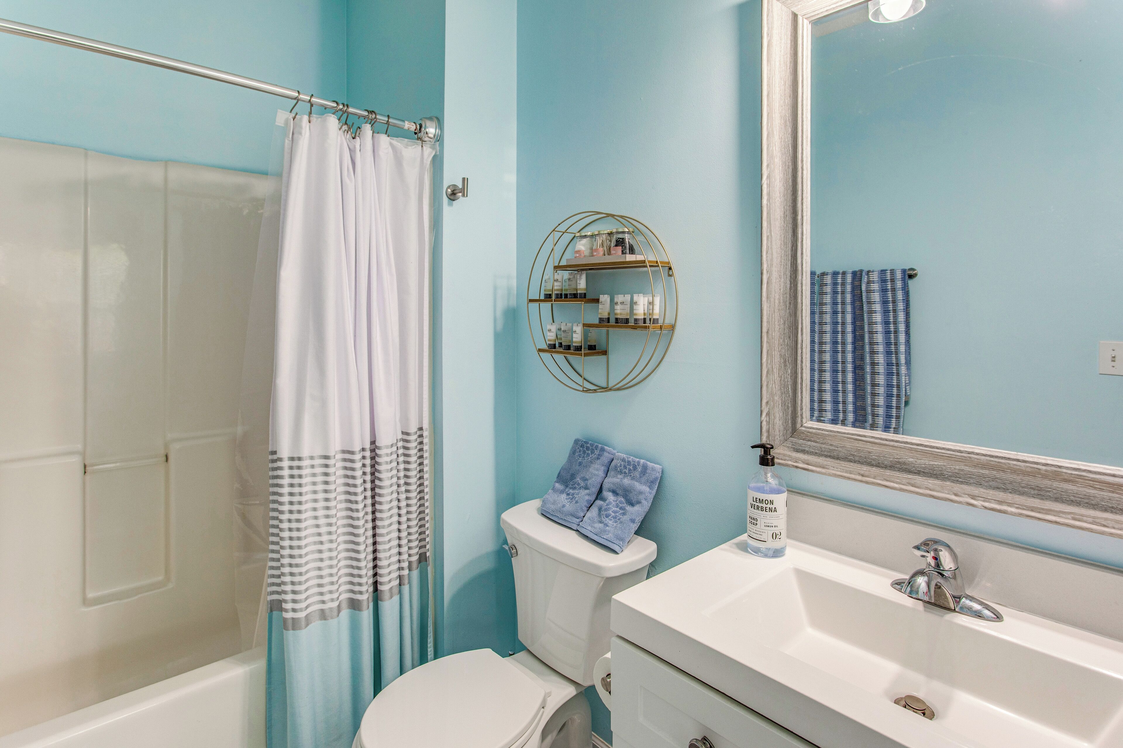A bathroom with a toilet, sink, and shower.