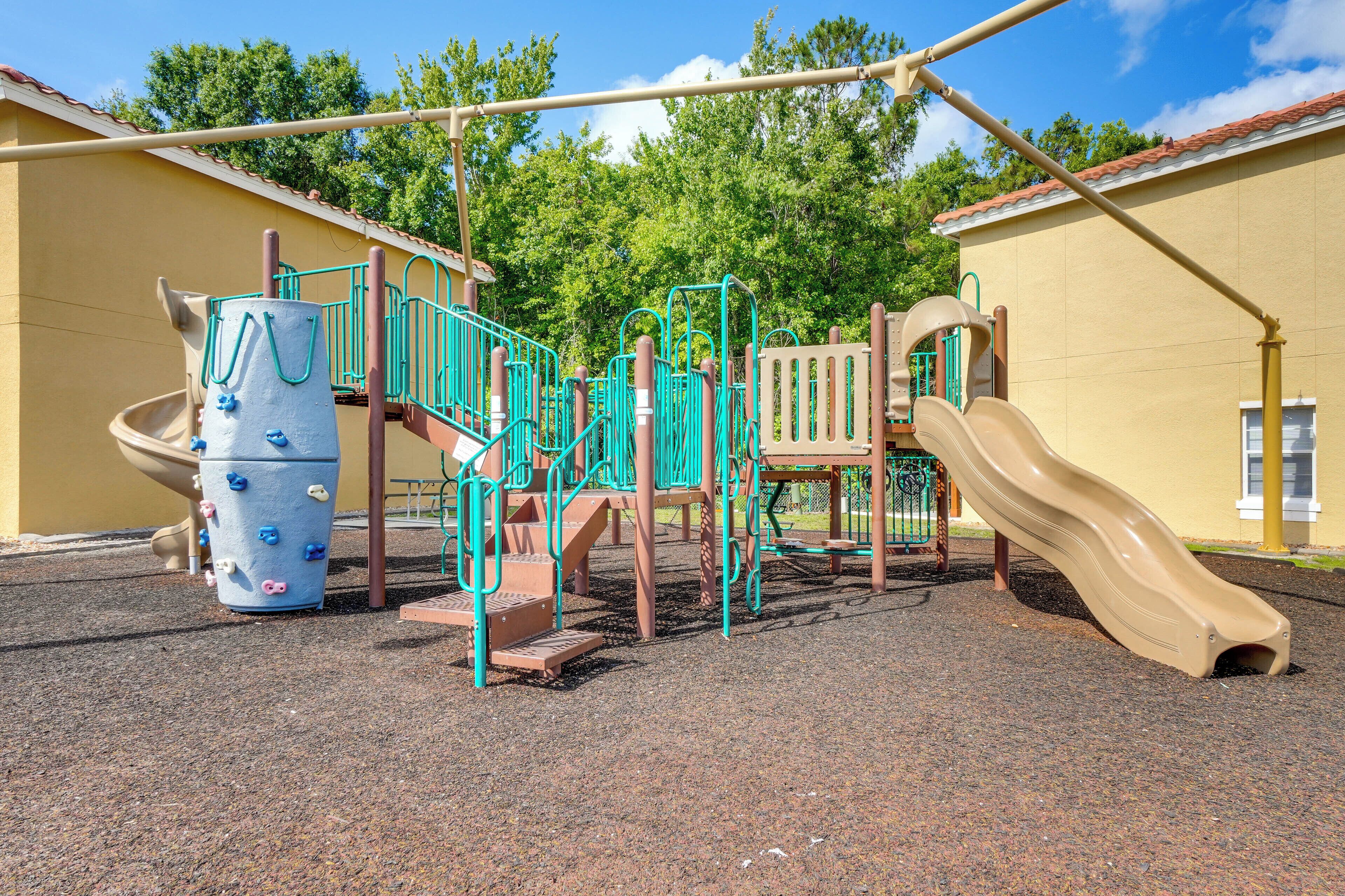 A playground with climbing structures, a slide, and a ball pit.