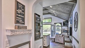 A cozy interior with a fireplace, bookshelves, a sofa, and a TV. - Floating Home on Columbia River w/ Provided Kayaks (Vancouver)
