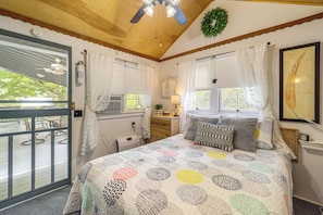 A bedroom with a bed, a window, a door, and a ceiling fan. - 6 Mi to Grandfather Mtn: Lake Cottage w/ Deck (Newland)