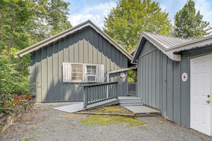 A two-story building with a porch and a garage. - 6 Mi to Grandfather Mtn: Lake Cottage w/ Deck (Newland)