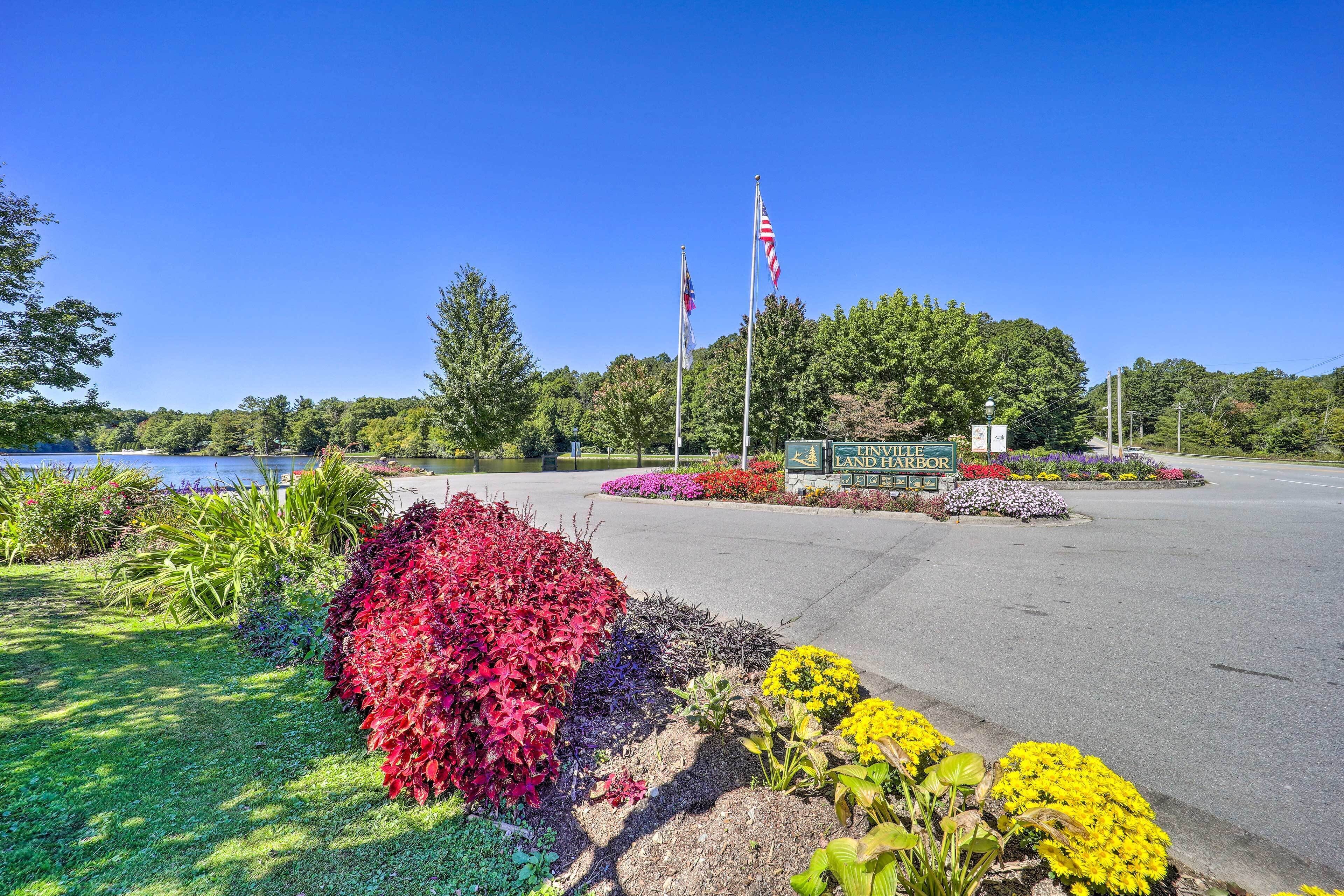 A parking lot with a sign for "HIGHLAND LAND & HARBOUR" and two flags.