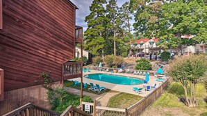 A pool area with lounge chairs and a wooden deck. - Fireplace, Pool Access: Waterfront Hot Springs Gem (Hot Springs)