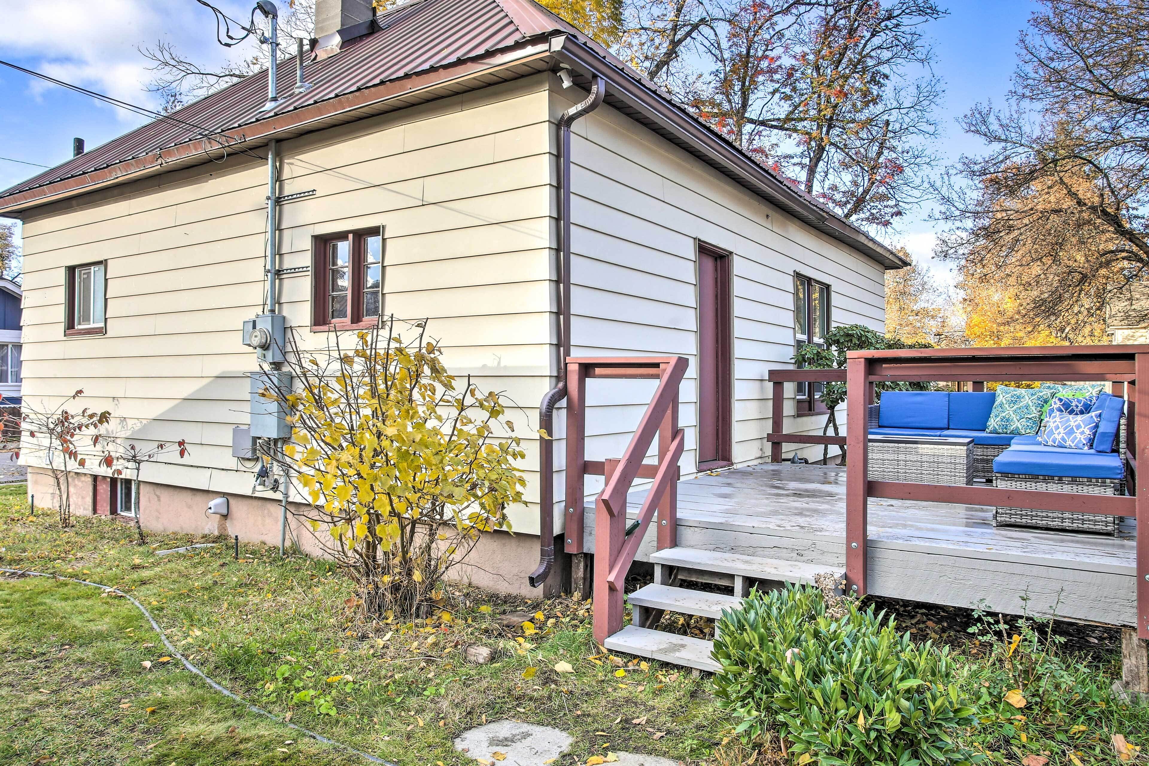 A house with a wooden deck and a blue outdoor sofa.