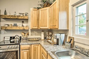 A kitchen with wooden cabinets, a stainless steel stove, and a granite countertop. - High-end & Homey Family Abode: Walk Downtown! (Coeur d'Alene)