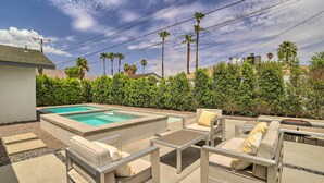 A backyard with a rectangular pool, beige outdoor furniture, and a well-maintained hedge. - Palm Springs Retreat w/ Private Pool & Spa! (Palm Springs)