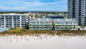 A beachfront hotel with multiple balconies, a pool, and a beach view. - Oceanfront Panama City Beach Condo w/ Balcony! (Panama City Beach)