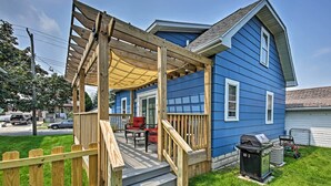 A blue house with a wooden deck, a barbecue grill, and a covered patio area. - 'ania's Retreat' w/ Deck: Walk to Lake Michigan! (Two Rivers)