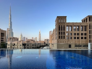 A swimming pool with a view of the Burj Khalifa and surrounding buildings.