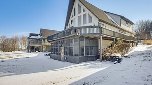 A large, modern house with a prominent gable roof and large windows. - Apple Valley Home, Shared Golf Course On-site (Howard)