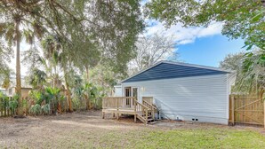 A small, single-story building with a wooden deck and a covered porch. - Colorful Cottage 1 Mi to Historic District! (St. Augustine)