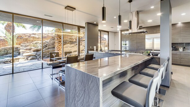 A modern kitchen with a large island, built-in appliances, and a view of a natural rock formation. - Palm Springs Retreat w/ Private Pool & Jacuzzi (Palm Springs)