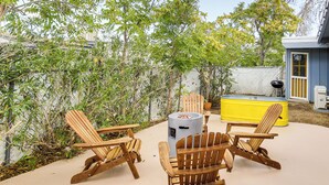 An outdoor patio with wooden Adirondack chairs, a yellow hot tub, and a barbecue grill. - Group Friendly! Gem 5 Mi to Joshua Tree Nat'l Park (Joshua Tree)