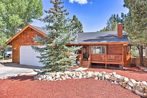 Enjoy a peaceful retreat in this cozy cabin with a spacious porch and separate garage, surrounded by a beautifully maintained garden.