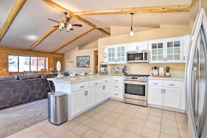 Enjoy cooking in this well-equipped kitchen with an oven, microwave, and large island with a sink.
