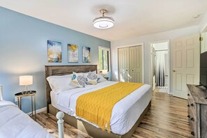 Cozy retreat with a large bed, wooden headboard, and modern lighting.