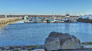 A marina with boats docked, a pier, and a large rock in the foreground. - Inviting Salem Apartment Near Waterfront & Museums (Salem)
