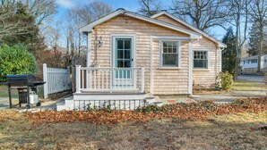 A small, single-story house with a front porch and a garage.
